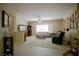 Open-concept living room with neutral walls, tile flooring, and a ceiling fan at 1830 Lake Wales St, Henderson, NV 89052