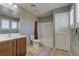 A well-lit bathroom featuring tile floors, a shower-tub combo, and a single sink vanity at 1904 Via Firenze, Henderson, NV 89044
