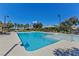 Resort-style pool with clear blue water, lounge chairs, umbrellas, and lush landscaping for relaxation and recreation at 1904 Via Firenze, Henderson, NV 89044