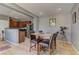 Cozy dining area with wooden table and chairs, open to the kitchen with stainless steel appliances at 1904 Via Firenze, Henderson, NV 89044