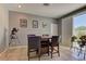 Dining area with neutral gray walls, tile floor, recessed lights and a modern table for four at 1904 Via Firenze, Henderson, NV 89044