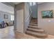 Inviting entryway with tiled floor, carpeted stairs, and view of the living room at 1904 Via Firenze, Henderson, NV 89044