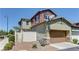 A two-story house with a brown garage and neutral colored siding at 1904 Via Firenze, Henderson, NV 89044