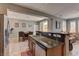 Open kitchen featuring granite countertops and stainless steel appliances, seamlessly flowing into the dining and living areas at 1904 Via Firenze, Henderson, NV 89044