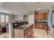 Open concept kitchen with granite countertops, stainless steel appliances, and a view into the living area at 1904 Via Firenze, Henderson, NV 89044