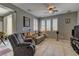 Comfortable living room with neutral tones, tile flooring, shutters and a ceiling fan at 1904 Via Firenze, Henderson, NV 89044