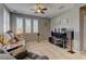 Living room featuring neutral walls, tile flooring, bright windows, and a ceiling fan at 1904 Via Firenze, Henderson, NV 89044