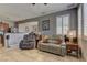 Spacious living room open to kitchen featuring tile flooring, neutral paint, and bright window shutters at 1904 Via Firenze, Henderson, NV 89044