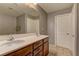 Main bathroom features double sinks with a wood vanity and tile flooring at 1904 Via Firenze, Henderson, NV 89044