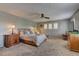 Spacious main bedroom featuring a ceiling fan and windows with white shutters at 1904 Via Firenze, Henderson, NV 89044