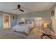 Bright main bedroom with a ceiling fan, and adjacent access to the main bathroom at 1904 Via Firenze, Henderson, NV 89044