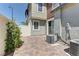 A brick-paved patio area with green bushes and part of the exterior wall at 1904 Via Firenze, Henderson, NV 89044