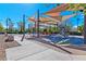 Community playground with shade canopies, swings, climbing structures, and seating areas for families to enjoy at 1904 Via Firenze, Henderson, NV 89044