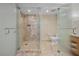Modern bathroom featuring glass-enclosed shower and toilet, with natural stone tile work at 2000 N Fashion Show Dr # 3000, Las Vegas, NV 89109