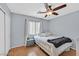 Simple bedroom with a ceiling fan, laminate floors, and a window providing natural light at 2011 Mountain Sunset Ave, North Las Vegas, NV 89031