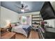Cozy bedroom featuring a large bed, blue ceiling, and a window overlooking the backyard at 2011 Mountain Sunset Ave, North Las Vegas, NV 89031