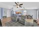 Open-concept living room with tile floors, ceiling fans, and view to the kitchen at 2011 Mountain Sunset Ave, North Las Vegas, NV 89031