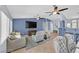 Bright living room featuring tile flooring, ceiling fans, and comfortable seating at 2011 Mountain Sunset Ave, North Las Vegas, NV 89031