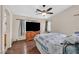 Bright main bedroom with a ceiling fan, hardwood floor, and ensuite bath access at 2011 Mountain Sunset Ave, North Las Vegas, NV 89031