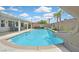 Inviting backyard pool with a slide, covered patio, and lush landscaping under a blue sky at 2011 Mountain Sunset Ave, North Las Vegas, NV 89031
