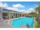 Backyard pool features a slide, lush landscaping, and a covered patio with solar panels on the roof at 2011 Mountain Sunset Ave, North Las Vegas, NV 89031