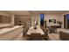Spacious dining room featuring a marble table, seating for 8, and modern lighting at 25 Sand Star Ln, Henderson, NV 89011