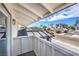 Charming balcony view showcasing the neighborhood street with trees and single story homes against a beautiful sky at 2611 Siesta Ave, Las Vegas, NV 89121