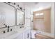 Updated bathroom featuring double sinks, black fixtures, and a walk-in shower at 2611 Siesta Ave, Las Vegas, NV 89121