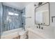 Stylish bathroom showcasing blue tiled walls, modern black fixtures, and a white vanity with a sink at 2611 Siesta Ave, Las Vegas, NV 89121