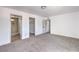 Spacious carpeted bedroom with white walls and doors to an ensuite bathroom and closet at 2611 Siesta Ave, Las Vegas, NV 89121