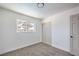 Bedroom with neutral colored walls and carpet with a view from the window and a closet at 2611 Siesta Ave, Las Vegas, NV 89121