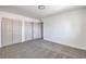 Bedroom with neutral colored walls and carpet featuring two closets and a view into another room at 2611 Siesta Ave, Las Vegas, NV 89121