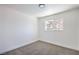 A bright bedroom featuring neutral colored walls and carpet and a window at 2611 Siesta Ave, Las Vegas, NV 89121