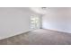 Bright, carpeted bedroom featuring a sliding glass door to a balcony with exterior views at 2611 Siesta Ave, Las Vegas, NV 89121