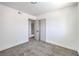 A bedroom with neutral colored walls and carpet and a view into another room at 2611 Siesta Ave, Las Vegas, NV 89121
