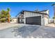 Updated exterior featuring a black garage door and xeriscaping at 2611 Siesta Ave, Las Vegas, NV 89121