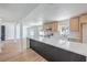 Open kitchen featuring a long breakfast bar, wood floors, and stainless appliances at 2611 Siesta Ave, Las Vegas, NV 89121