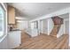 A modern, open kitchen with light wood floors, white cabinets and staircase at 2611 Siesta Ave, Las Vegas, NV 89121