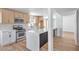 Modern kitchen featuring a large island with quartz countertops, stainless steel appliances, and ample cabinet space at 2611 Siesta Ave, Las Vegas, NV 89121