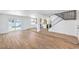 Open-concept living space featuring wood-look floors, stairs, and access to a backyard pool at 2611 Siesta Ave, Las Vegas, NV 89121