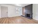 A newly renovated living room with wood floors features a black fireplace and a side door at 2611 Siesta Ave, Las Vegas, NV 89121