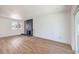 Spacious living room with hardwood floors, black brick fireplace, and a bright window at 2611 Siesta Ave, Las Vegas, NV 89121