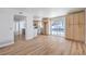 Bright living space featuring wood-look floors, kitchen view, and access to outdoor pool area at 2611 Siesta Ave, Las Vegas, NV 89121
