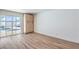 Bright room with wood-look floors, access to pool view, and built-in storage cabinets at 2611 Siesta Ave, Las Vegas, NV 89121
