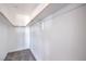 A walk-in closet with neutral walls and carpet and wood rails for hanging clothing at 2611 Siesta Ave, Las Vegas, NV 89121