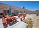 Backyard oasis featuring a wooden hot tub, picnic table, and built-in grill for outdoor entertaining at 2716 Orchid Moon Ct, North Las Vegas, NV 89031