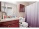 Bathroom featuring a granite countertop vanity, cabinet storage, and shower with curtain at 2716 Orchid Moon Ct, North Las Vegas, NV 89031