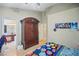 Bedroom features a large armoire, wood flooring, and ensuite bath, offering comfort and privacy at 2716 Orchid Moon Ct, North Las Vegas, NV 89031