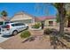 Charming single-story home with desert landscaping, a well-maintained lawn, and a two-car garage at 2716 Orchid Moon Ct, North Las Vegas, NV 89031