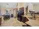Bright kitchen featuring tiled countertops and backsplash, dark cabinetry, and black appliances at 2716 Orchid Moon Ct, North Las Vegas, NV 89031